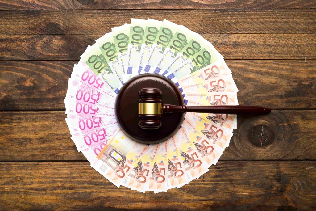 Cash and a judge's gavel on a desk